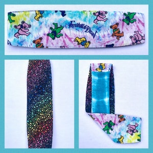 May include: A tie-dye headband with a rainbow polka dot pattern on the inside. The headband features a Grateful Dead logo and dancing bears.