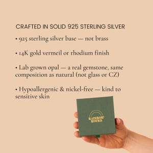 May include: A square dark green jewelry box with the gold text RAINBOW ROCKS and a rainbow icon. Text above reads: CRAFTED IN SOLID 925 STERLING SILVER, 925 sterling silver base, 14K gold vermeil or rhodium finish, lab grown opal, hypoallergenic & nickel-free.