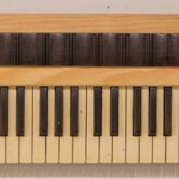Recycled from an antique organ, a piano wall hanging