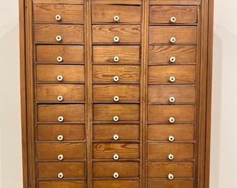 Wall hung 30- drawer primitive cabinet signed by Rusty Wolfe