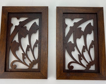 Pair of walnut cutouts framed in mahogany