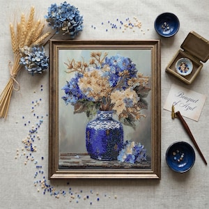May include: A framed artwork depicts a blue vase filled with blue and beige flowers. The vase is adorned with a white lace-like design. The artwork is surrounded by small blue bowls, a small box, and a handwritten note that says "Bouquet of Azul."