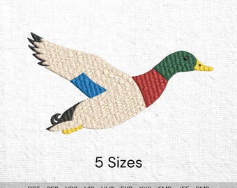 May include: An embroidered design of a flying duck, featuring a beige body, a blue wing patch, and a green head with a yellow beak. The duck has red and black accents. The text "5 Sizes" is below the duck.