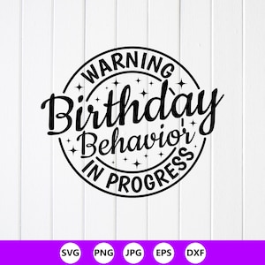 May include: A black and white circular design featuring the text "WARNING Birthday Behavior IN PROGRESS". The text is in a bold, playful font, encircled with star accents. The background is white with vertical wooden panels.
