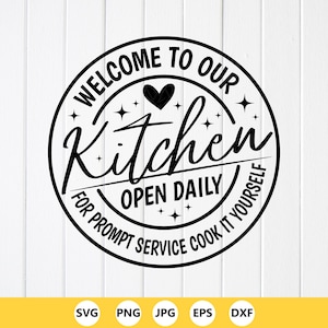 May include: A black and white circular sign with the text "WELCOME TO OUR Kitchen" and "FOR PROMPT SERVICE COOK IT YOURSELF". The sign also includes the words "OPEN DAILY" and a heart symbol.