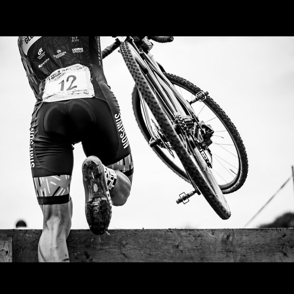 Cyclocross - A high quality photo featuring the effort and power of a cyclocross bike racer in action.