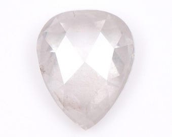 May include: A pear-shaped, faceted gemstone with a pale, translucent appearance. The gem has a pointed end and a rounded top, with multiple facets creating a sparkling effect. The stone is set against a white background.