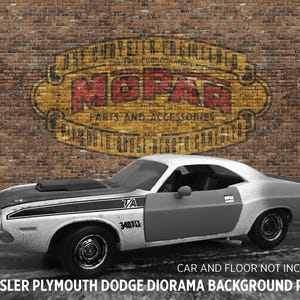 May include: A model of a classic white and black muscle car with the door open, featuring a black hood and a racing stripe. The car is parked in front of a brick wall with a vintage MOPAR sign. The text "TA 340" is visible on the side.