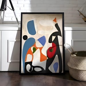 May include: Abstract art print in a black frame with blue, orange, red, and black shapes. A black globe on a tripod stand and a model sailing ship are also visible. A woven basket sits on the floor.
