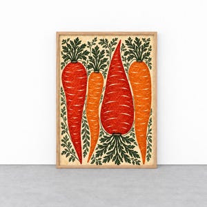 May include: A framed wall art print featuring four stylized carrots in shades of orange and red, each topped with detailed dark green leafy foliage. The carrots are arranged vertically against a light cream background within a wooden frame.
