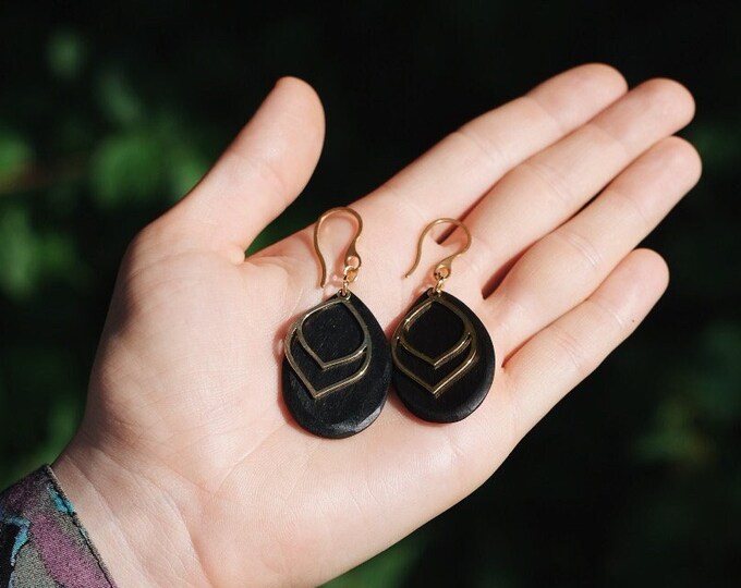 Gold-plated hanging earrings with hand-carved ebony disc