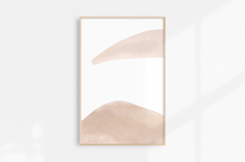 May include: Abstract art print with two soft pink watercolor shapes on a white background. The shapes are organic and flowing, creating a minimalist and modern aesthetic.