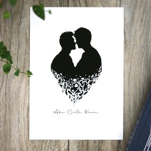 May include: Black and white silhouette of two people kissing, forming a heart shape with their bodies. The text "Aku Cinta Kamu" is written below the silhouette.