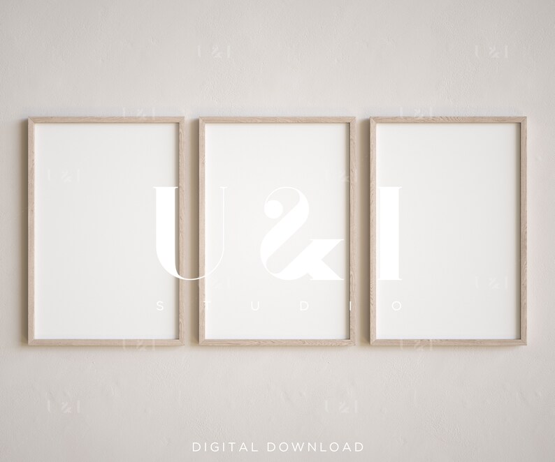 May include: Three framed prints with the letters "U", "&", and "I" in a modern, minimalist style. The frames are light wood and the letters are white against a white background.