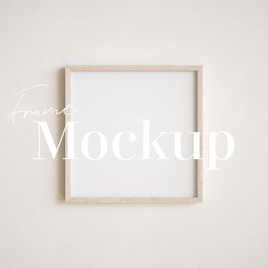 May include: A simple, light wood frame mockup on a white wall. The frame is square and has a white mount. The text "Frame Mockup" is written in white text on the wall.