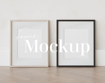 May include: Two empty picture frames, one with a natural wood finish and one with a black finish, are displayed against a white wall. The frames are both rectangular and have a simple design. The word "Frame Mockup" is written in white text across the center of the image.