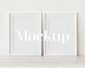 May include: Two white picture frames with a white background. The frames are empty and ready for a mockup. The text "Frame Mockup" is written in white on the frames.