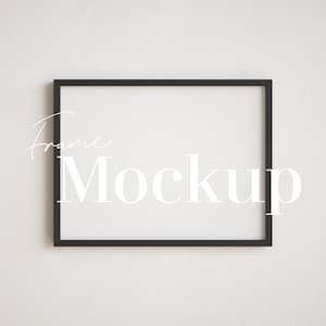 May include: A black frame mockup on a white wall. The text "Frame Mockup" is written in white on the frame.