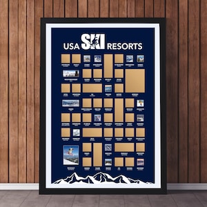 May include: Framed USA Ski Resorts scratch-off poster. The navy blue poster features gold scratch-off squares, ski resort images, and white text. The top text reads "USA Ski Resorts". A skier is shown in the bottom left corner.