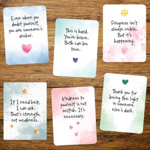May include: Six inspirational quote cards with watercolor backgrounds and hearts, stars, and a sun graphic. The cards feature phrases like "Even when you doubt yourself, you are someone's anchor" and "Kindness to yourself is not selfish."