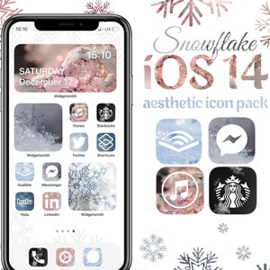 Puede incluir: Una captura de pantalla de un iPhone con un paquete de iconos estéticos iOS 14 con temática de copos de nieve. Los iconos están en un patrón de cuadrícula y presentan una variedad de aplicaciones, incluidas Twitter, Starbucks y Audible. El fondo es un diseño de copo de nieve rosa y blanco.