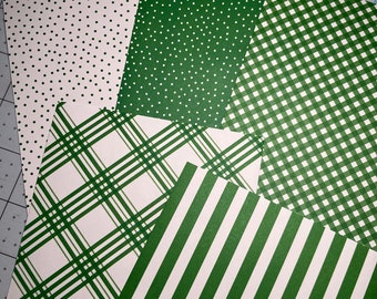 May include: Five sheets of green and white patterned paper. The patterns include polka dots, stripes, gingham, and plaid.
