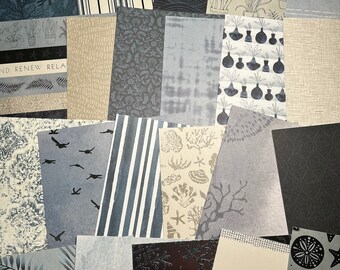 May include: A collection of patterned paper sheets in various shades of blue, black, and beige. The patterns include stripes, plants, seashells, and geometric designs. The text "AND RENEW RELA" is visible on one of the sheets.