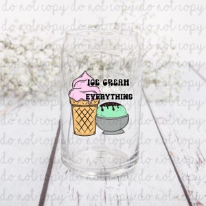 May include: A clear glass with a pink and green ice cream cone and scoop design. The text "ICE CREAM solves EVERYTHING" is printed on the glass.