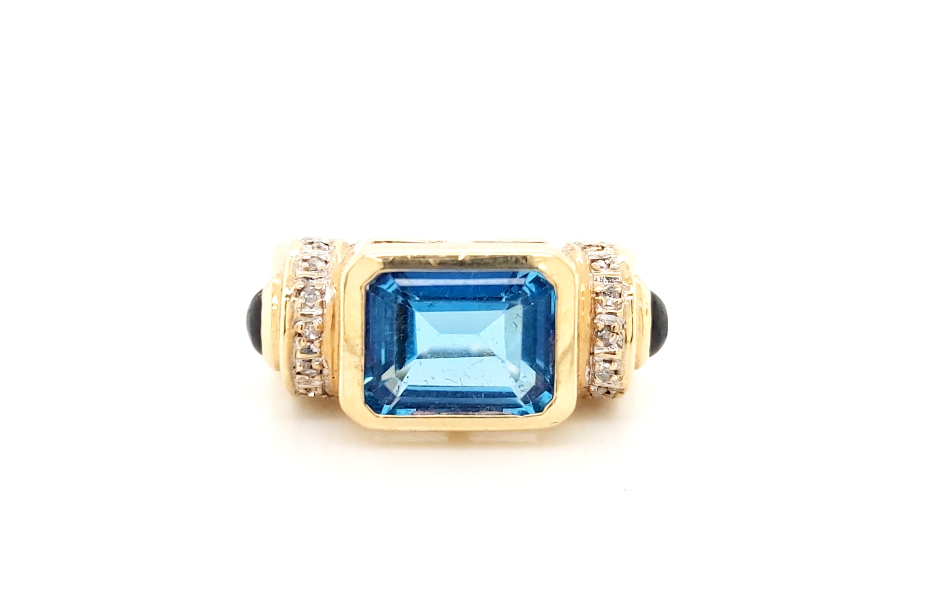 Anillo de oro amarillo de 14 k con topacio azul (piedra natal de diciembre) y diamantes