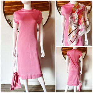 May include: A pink sleeveless dress with a scoop neck and a slightly flared hem. The dress is shown on a mannequin with a white background.