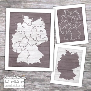 May include: Three framed prints of the map of Germany. The prints are in white frames, with a gray background. The maps are white, with the borders of the states clearly visible. The text "Laserdatei von Life Line Gestaltung" is at the bottom.