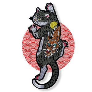 May include: Embroidered patch of a grey tabby cat with a dragon design on its back, set against a red and white circular background with a wave pattern. The patch has a detailed, artistic design.