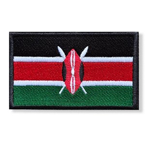 May include: A rectangular embroidered patch featuring the flag of Kenya. The design consists of horizontal black, red, and green stripes separated by thin white lines. In the center, a red, black, and white Maasai shield with two crossed spears.