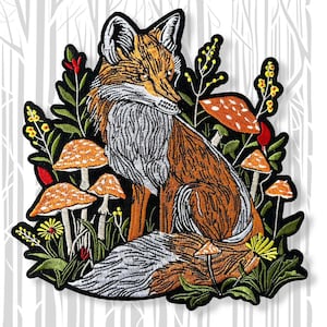 May include: Embroidered patch featuring a fox with orange and white fur, surrounded by orange-capped mushrooms, green foliage, and yellow flowers. The patch has a black border and is set against a white and gray tree background.