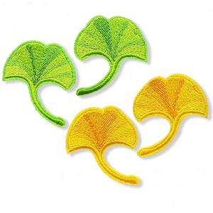May include: Four embroidered iron-on patches in the shape of ginkgo leaves. Two patches are green and two are yellow.
