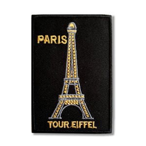 May include: Black embroidered patch with a gold outline of the Eiffel Tower and the text "PARIS TOUR EIFFEL".
