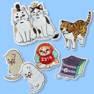 May include: A set of eight embroidered iron-on patches featuring various cats in different poses and outfits. The patches are made of felt and thread and are perfect for adding a touch of whimsy to clothing, bags, or other accessories.