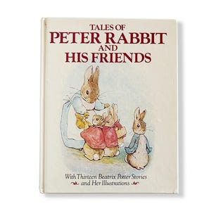 May include: A hardback book titled Tales of Peter Rabbit and His Friends with Thirteen Beatrix Potter Stories and Her Illustrations. The off-white cover features a watercolour illustration of several rabbits in clothing.