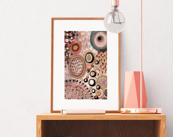 May include: A framed print of an abstract painting with a pink, brown, and green color scheme. The painting features a variety of circles and other shapes.