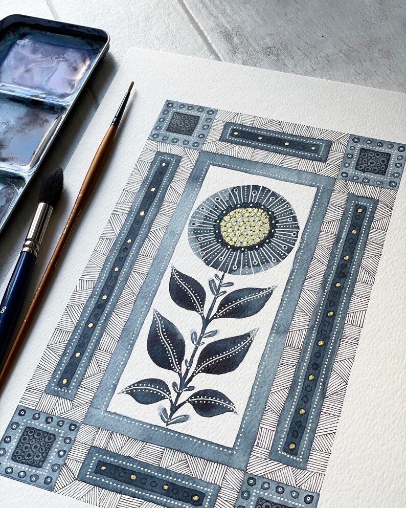 May include: A watercolor painting of a stylized flower with blue and gold accents. The flower is surrounded by a geometric pattern of squares and lines.
