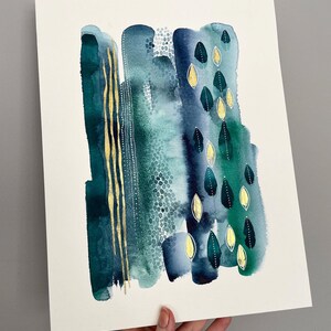 May include: Abstract watercolor painting with blue, green, and gold accents. The painting features a series of vertical brushstrokes with gold leaf details and a pattern of small dots.