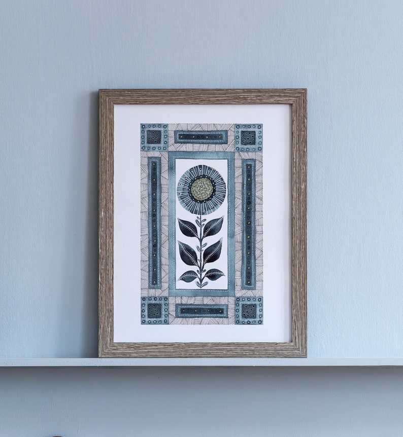 May include: A framed print of a stylized blue and gray flower with geometric patterns. The flower is surrounded by a border of geometric shapes.