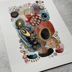 May include: Abstract watercolor painting with gold accents. The painting features a variety of shapes and patterns, including circles, dots, and lines. The colors are mostly red, blue, and gold.
