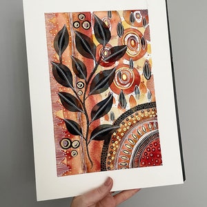 May include: Watercolor painting of a stylized plant with black leaves and a white stem on a background of red, orange, and gold abstract shapes and patterns.