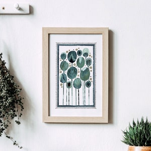 May include: A framed print of a watercolor painting depicting a forest of stylized trees with blue and green foliage. The trees are arranged in a cluster and have a whimsical, abstract design.