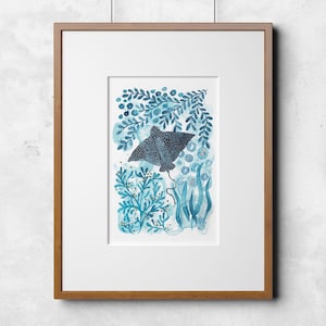 May include: A framed watercolor painting of a blue stingray swimming through a blue and gold underwater scene.