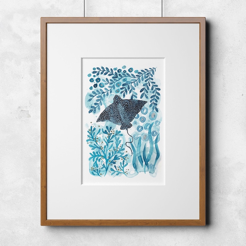May include: A framed watercolor painting of a blue stingray swimming through a blue and gold underwater scene.