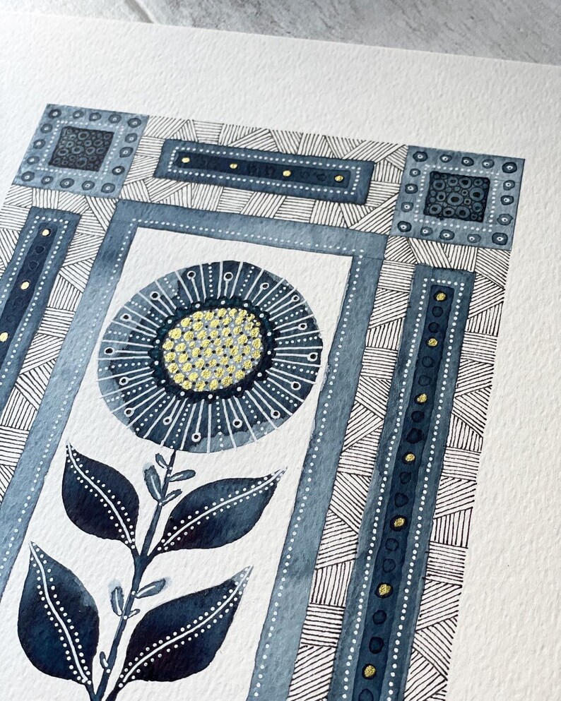 May include: A watercolor painting of a stylized flower with blue and gold accents. The flower is surrounded by a geometric pattern in shades of blue.