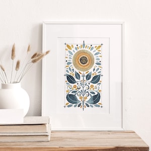 May include: A framed watercolor print of a stylized sunflower with blue and yellow petals and leaves. The background is white.