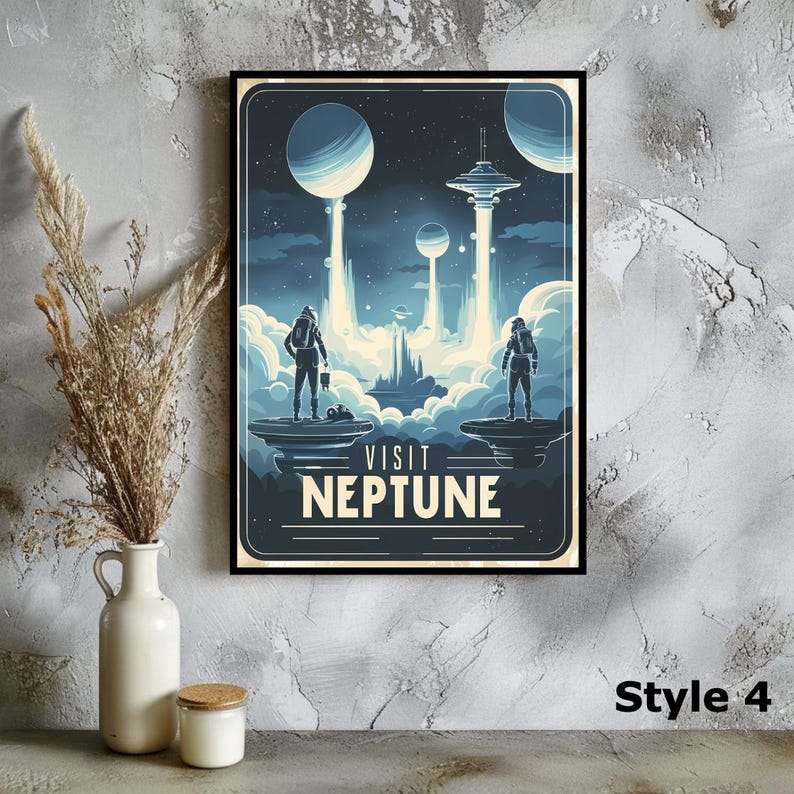 May include: A framed art print with a retro space travel theme. The artwork features two astronauts on a planet, with the text "VISIT NEPTUNE" below. The color palette is primarily blue and white, with a vintage poster style.